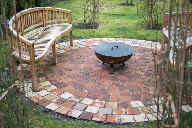 istock Stone circle with cozy bench and fire bowl in your own garden 1212554501