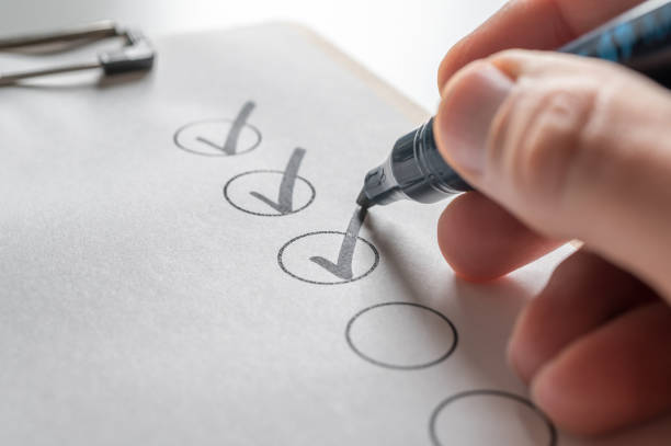 istock Check off a to-do list with a black pen 1212554542