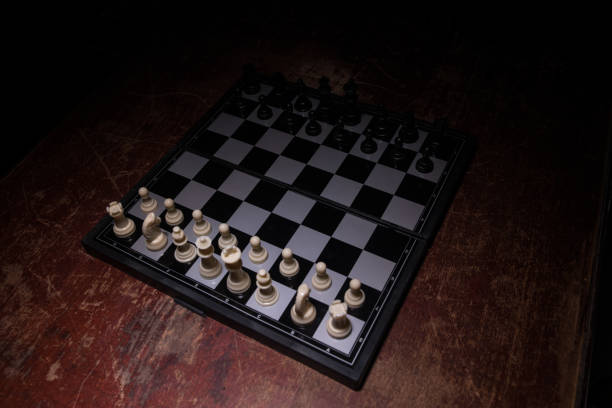 istock Chess figures on a dark background with smoke and fog. Selective focus 1212554619