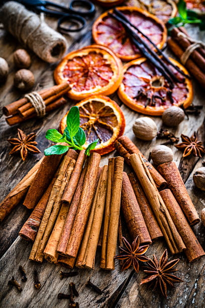 istock Scented spices: cinnamon sticks shot on rustic wooden table 1212556368