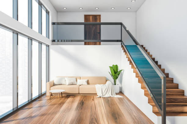 istock Panoramic white living room with sofa and stairs 1212556415