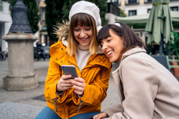 istock Two caucasian girls using a smartphone. 1212557000