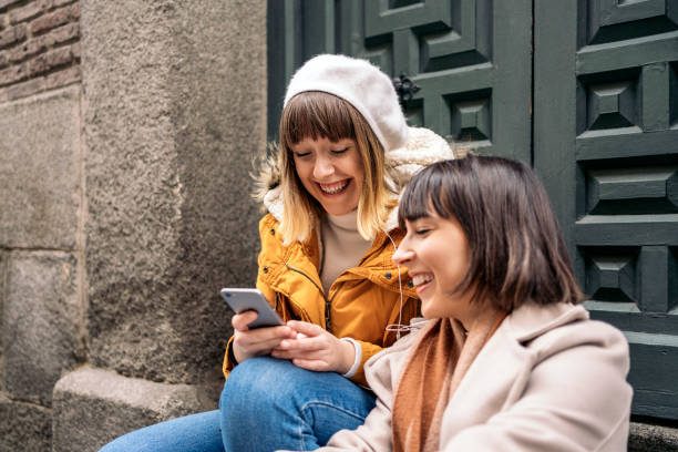 istock Two caucasian girls using a smartphone. 1212557013