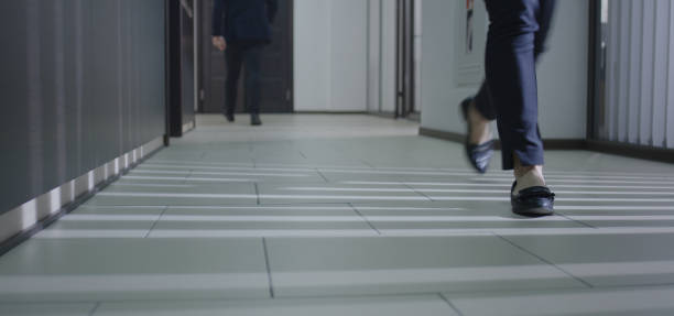 istock Business people walking in corridor 1212557160