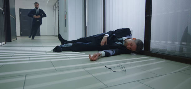 istock Coworkers running to help unconscious manager 1212557307