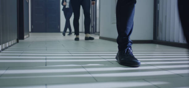 istock Business people walking in corridor 1212557322