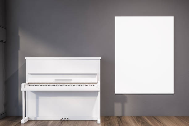 istock White piano in gray room with poster 1212558558
