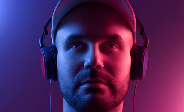 istock Young man in headphones. Two-tone lighting 1212559105