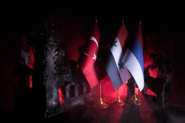 Concept of crisis of war and political conflicts between nations Turkey, Russia and Syria flag on dark background. Concept of crisis of war and political conflicts between nations. Selective focus coalition building stock pictures, royalty-free photos & images