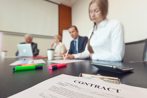 Business people working with contract at meeting in office