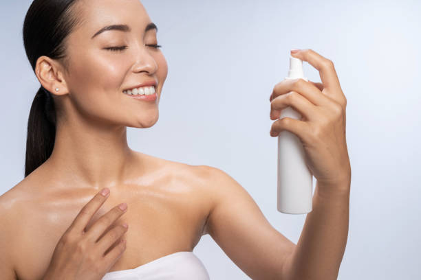 istock Smiling Asian lady is applying thermal water 1212560910