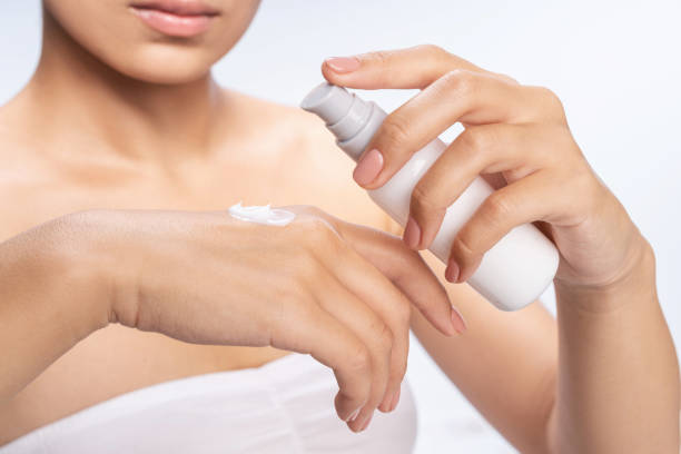 istock Pretty young woman getting cream in studio 1212560919