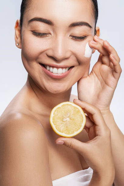 istock Smiling pretty lady posing with lotion and lemon 1212560991
