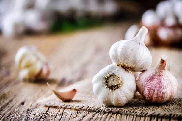 istock Fresh garlic on vintage table. Garlics clove. 1212567034