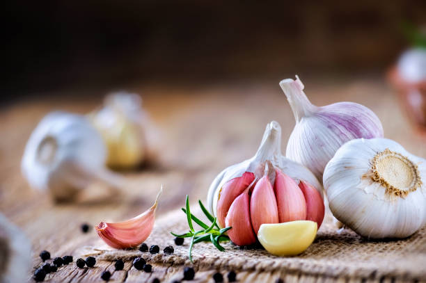 istock Fresh garlic on vintage table. Garlics clove. 1212567040