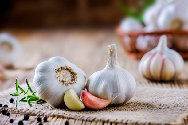 istock Fresh garlic on vintage table. Garlics clove. 1212567042
