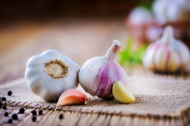 istock Fresh garlic on vintage table. Garlics clove. 1212567059