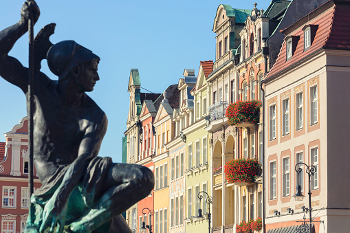 Sculpture of the Mars fountain (a replica of the original fountain) and old townhouses in the old town of Poznan, Poland.