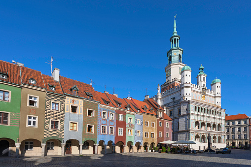 A row of old townhouses and the Poznan city hall on the old market square in the old town district.