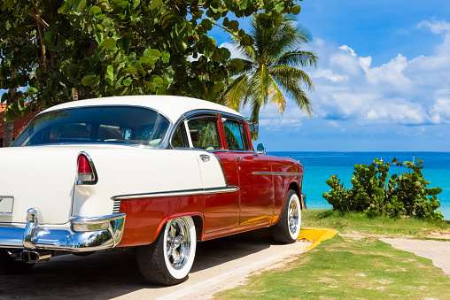 American red white 1955 classic car  parked direct on the beach in Varadero Cuba - Serie Cuba Reportage