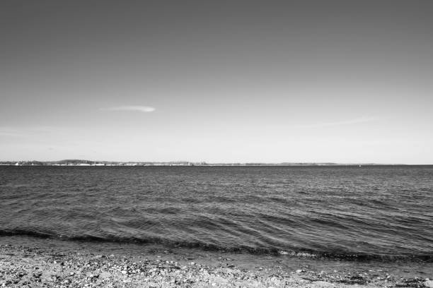 istock black and white rocky seashore, sky and sea 1212571246
