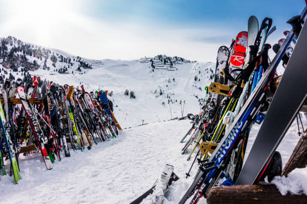 Skis and ski poles on top of ski resort.
