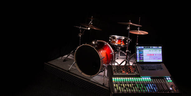 istock Digital mixer in a recording Studio , with a computer for recording music. On the background of the drum set. 1212573317