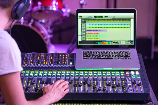 istock Digital mixer in a recording Studio , with a computer for recording music. On the background of the sound engineer at work. 1212573323