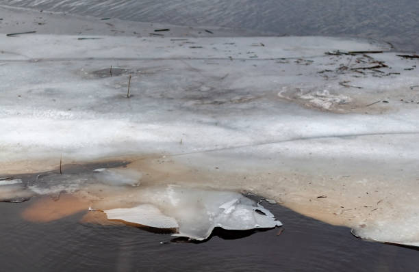 istock Thin pieces of ice by the river on a spring day 1212574092