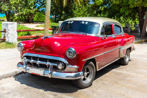 american red 1959 sport coupe classic car parked on the side street near the beach in varadero cuba - serie cuba reportage - cuba usa vintage car car fotografías e imágenes de stock