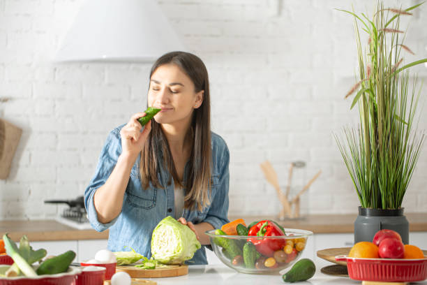 istock A young woman is preparing a salad in the kitchen . 1212575440