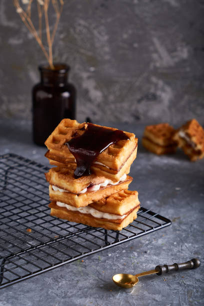 istock delicious homemade Vienna waffles with syrup served on a gray table Vertical 1212575478
