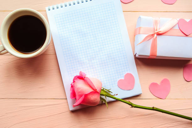 istock Love composition - coffee cup, gift box and red rose on pink background, top view. Valentines Day greeting card 1212577700