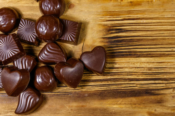 istock Tasty chocolate candies on wooden table. Top view, copy space 1212577792