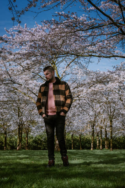 istock men walking in the public park in Amsterdam Netherlands during Spring with blooming cherry blossom trees 1212579092