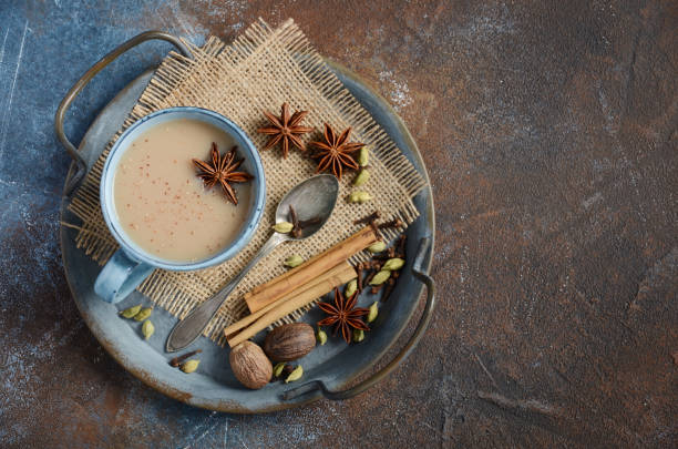 istock Indian masala chai tea. Spiced tea with milk on dark rusty background. 1212579174