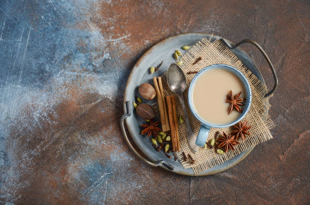 istock Indian masala chai tea. Spiced tea with milk on dark rusty background. 1212579182