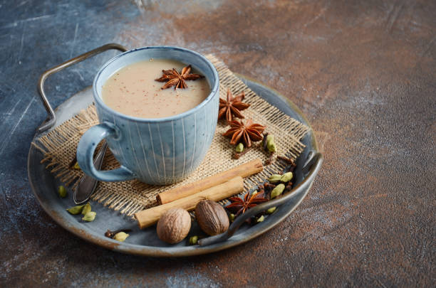 istock Indian masala chai tea. Spiced tea with milk on dark rusty background. 1212579190