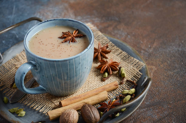 istock Indian masala chai tea. Spiced tea with milk on dark rusty background. 1212579214
