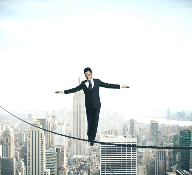 istock Businessman walking on rope 1212579228