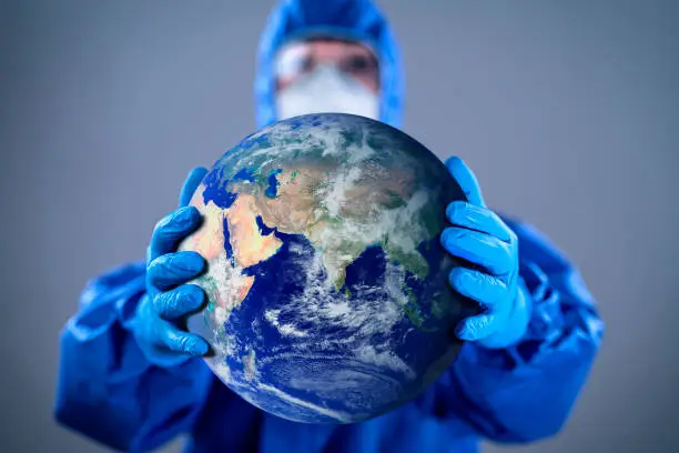 Doctor wearing highly protective suit and holding globe in her hands.
Globe link: https://visibleearth.nasa.gov/images/2181/the-blue-marble/2182w
