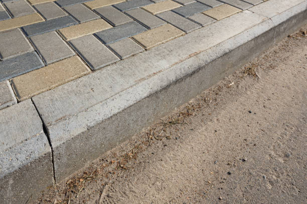 istock The colorful cobblestone pavement is divided with a concrete curb from the sidewalk. 1212581649