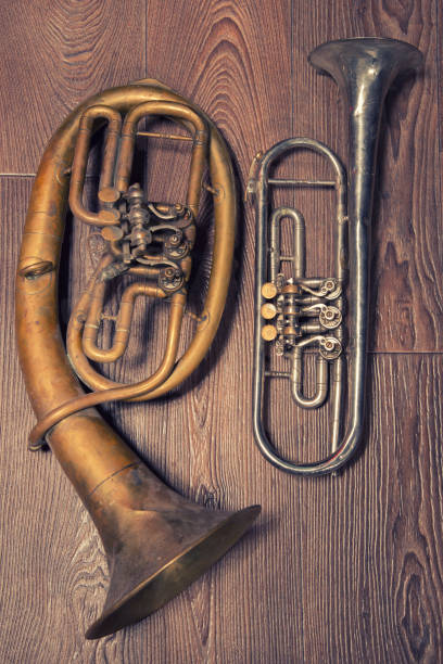 istock old brass wind instrument and horn  on a wooden background 1212583563