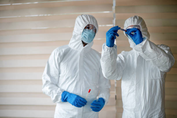 Doctor in scrubs hold a blood sample stock photo