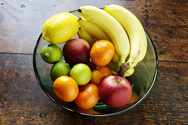 istock Glass Bowl Of Fruit On Oak Table 121258534