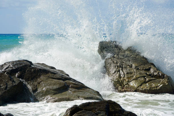 istock Sea waves bouncing onto rocks creating shower of water droplets 1212585528
