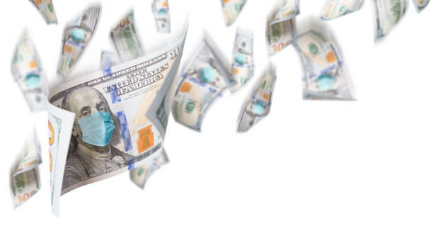 istock 100 Dollar Bills with Medical Face Mask Falling From Above On White Background 1212586249