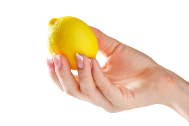 istock Lemon in woman hand isolated. 1212586317