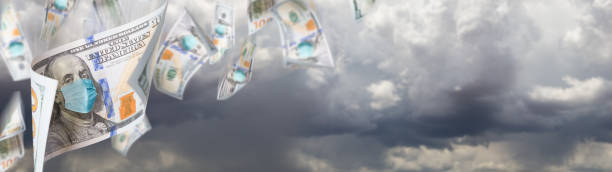 istock 100 Dollar Bills with Medical Face Mask Falling From Stormy Cloudy Sky Banner 1212586501