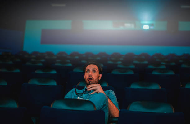 istock Young man watching a movie 1212586716